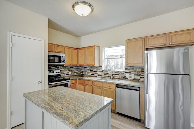 2802 Austin St, Houston, TX 77004 - kitchen with appliances with stainless steel finishes, a sink, tasteful backsplash, and light stone countertops