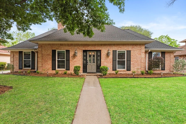 5918 Donwhite Ln, Houston, TX 77088 - view of front facade with a front yard, brick siding, roof with shingles, and a chimney
