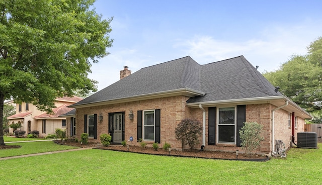 5918 Donwhite Ln, Houston, TX 77088 - view of front of house featuring cooling unit, a chimney, roof with shingles, and a front lawn