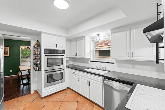 5918 Donwhite Ln, Houston, TX 77088 - kitchen with a sink, stainless steel appliances, plenty of natural light, and dark countertops