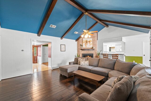 5918 Donwhite Ln, Houston, TX 77088 - living area with a ceiling fan, a fireplace, beamed ceiling, hardwood / wood-style floors, and baseboards