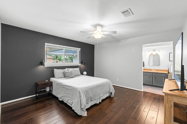 5918 Donwhite Ln, Houston, TX 77088 - bedroom featuring dark wood-style flooring, baseboards, a ceiling fan, and ensuite bath