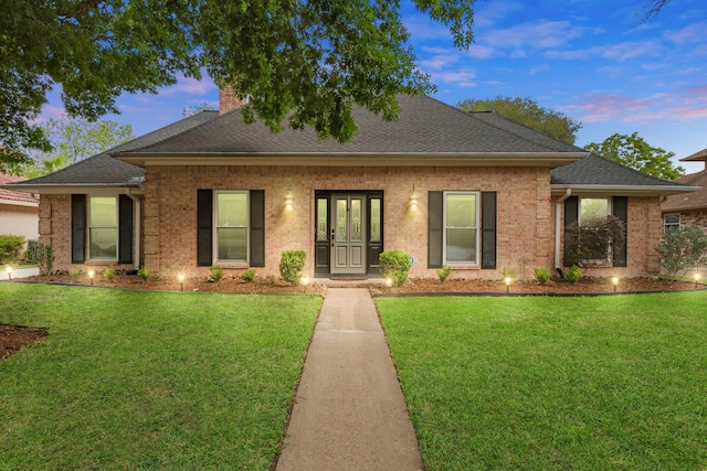 5918 Donwhite Ln, Houston, TX 77088 - view of front of home with brick siding, a front lawn, a chimney, and roof with shingles