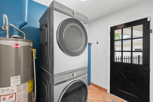 5918 Donwhite Ln, Houston, TX 77088 - laundry room featuring gas water heater, stacked washing machine and dryer, light tile patterned flooring, and baseboards