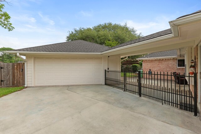5918 Donwhite Ln, Houston, TX 77088 - view of side of property featuring fence, concrete driveway, and a garage