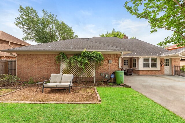 5918 Donwhite Ln, Houston, TX 77088 - back of house featuring brick siding, a patio, roof with shingles, and a chimney