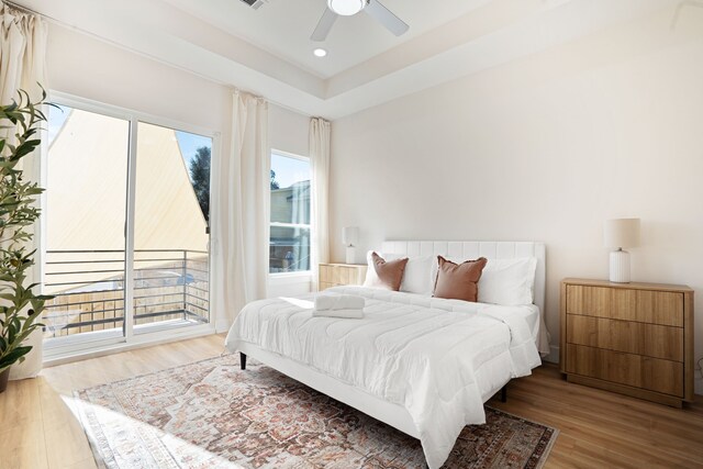 7612 Ave L, Houston, TX 77012 - bedroom with wood finished floors, access to outside, recessed lighting, a raised ceiling, and a ceiling fan