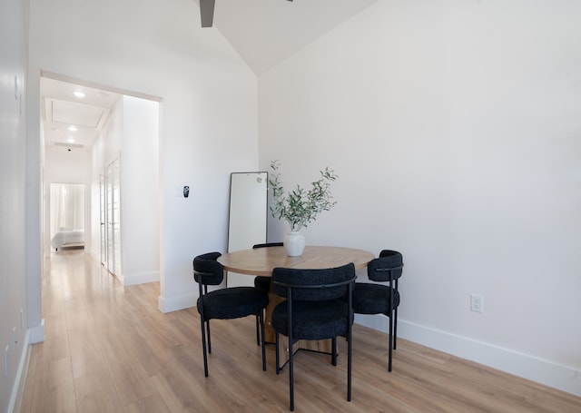 7612 Ave L, Houston, TX 77012 - dining space with light wood-type flooring, baseboards, and high vaulted ceiling