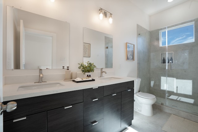 7612 Ave L, Houston, TX 77012 - bathroom featuring a stall shower, toilet, double vanity, and tile patterned floors