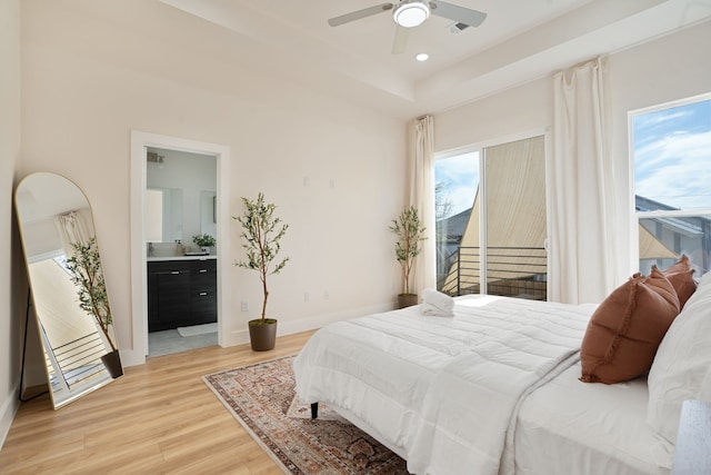7612 Ave L, Houston, TX 77012 - bedroom with light wood-type flooring, multiple windows, baseboards, ensuite bathroom, and recessed lighting