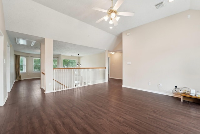2422 Acadiana Ln, Seabrook, TX 77586 - spare room featuring attic access, dark wood-type flooring, lofted ceiling, baseboards, and a ceiling fan