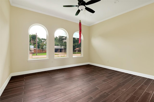 spare room with baseboards, dark wood-type flooring, ceiling fan, and ornamental molding