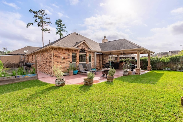18107 Banpo Ct, Houston, TX 77044 - rear view of house with a shingled roof, brick siding, a patio, and a chimney