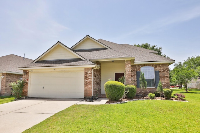 2202 Sugar Hill Dr, Deer Park, TX 77536 - traditional-style house featuring brick siding, a garage, roof with shingles, a front lawn, and concrete driveway