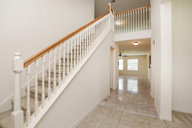 2202 Sugar Hill Dr, Deer Park, TX 77536 - stairs with baseboards, a ceiling fan, a towering ceiling, and marble finish flooring