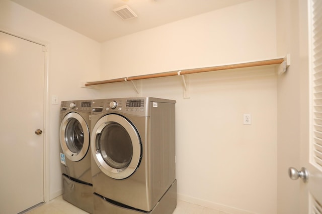 2202 Sugar Hill Dr, Deer Park, TX 77536 - laundry room with washing machine and dryer, baseboards, and light tile patterned floors