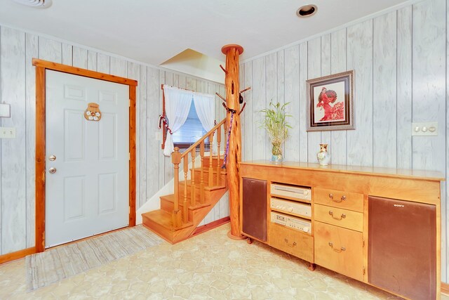 204 Rd 2764, Rye, TX 77327 - entryway featuring wooden walls, stairs, and crown molding