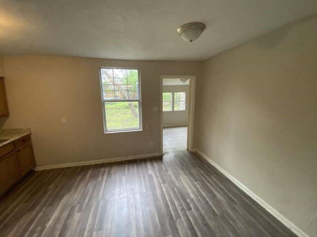 10110 Rosehaven Dr, Houston, TX 77051 - unfurnished dining area featuring baseboards and dark wood-style floors