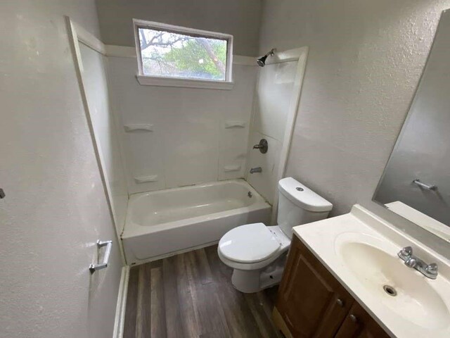 10110 Rosehaven Dr, Houston, TX 77051 - full bath featuring wood finished floors, a textured wall, toilet, vanity, and shower / bath combination