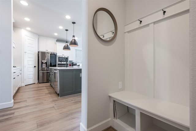 7507 Zion Grove Ct, Katy, TX 77493 - mudroom featuring light wood-style floors, recessed lighting, baseboards, and a sink