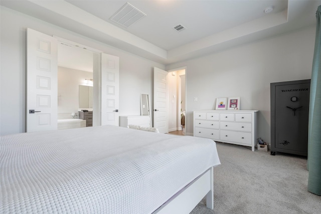 7507 Zion Grove Ct, Katy, TX 77493 - bedroom with light carpet, a tray ceiling, and ensuite bathroom