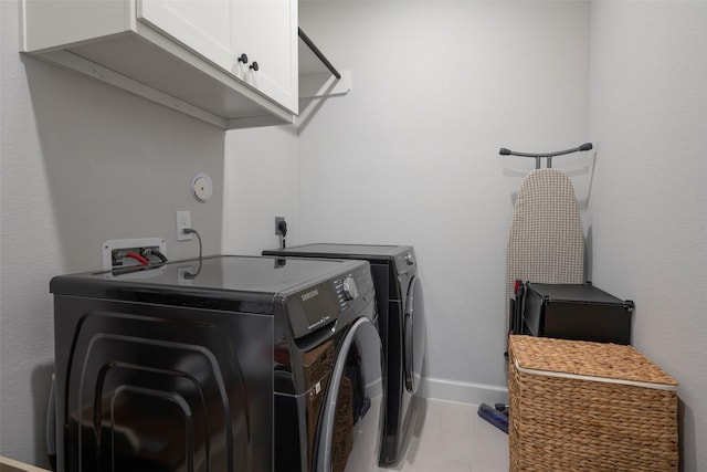 7507 Zion Grove Ct, Katy, TX 77493 - washroom with cabinet space, separate washer and dryer, baseboards, and light tile patterned floors