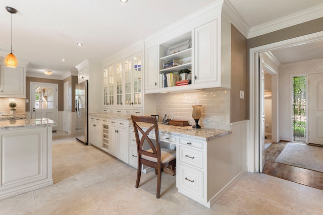 5407 Westminister Ct, Houston, TX 77069 - office featuring plenty of natural light, ornamental molding, wainscoting, light tile patterned flooring, and built in desk