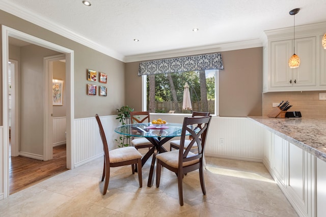 5407 Westminister Ct, Houston, TX 77069 - dining space featuring a wainscoted wall, light tile patterned flooring, and crown molding