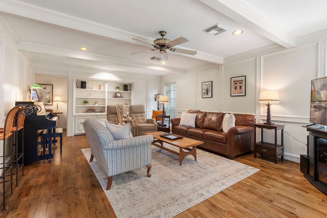 5407 Westminister Ct, Houston, TX 77069 - living room with crown molding, a ceiling fan, wood finished floors, beamed ceiling, and a decorative wall