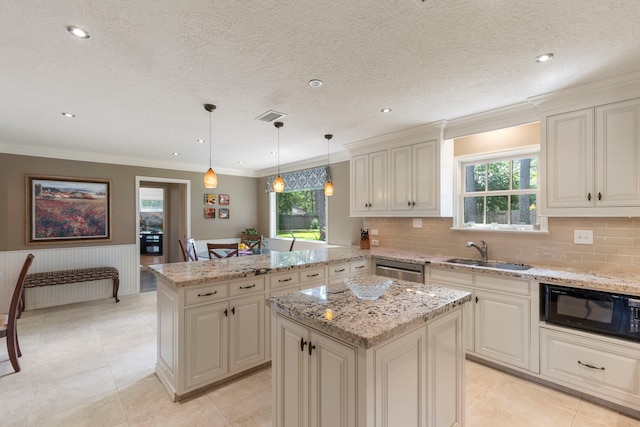 5407 Westminister Ct, Houston, TX 77069 - kitchen with a sink, a peninsula, plenty of natural light, light stone countertops, and wainscoting