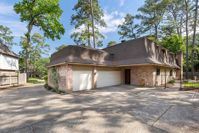 5407 Westminister Ct, Houston, TX 77069 - view of side of home with mansard roof, roof with shingles, brick siding, and fence