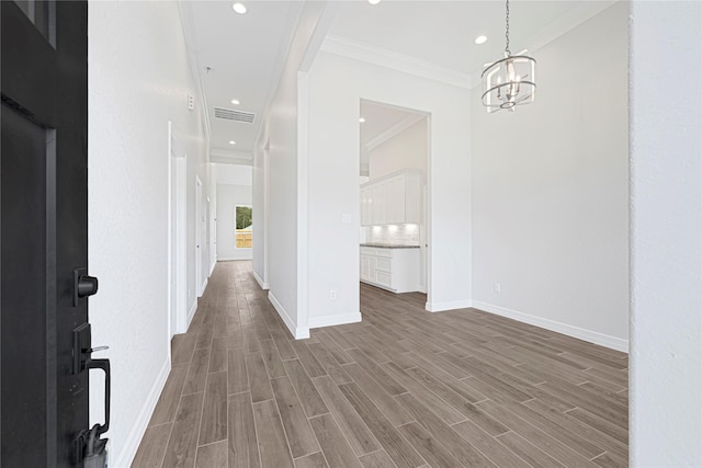 117 Big Spring Dr, Anahuac, TX 77514 - entrance foyer with crown molding, a chandelier, wood finished floors, baseboards, and recessed lighting