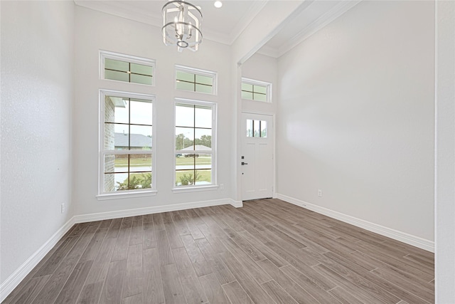 117 Big Spring Dr, Anahuac, TX 77514 - entrance foyer featuring a chandelier, wood finished floors, ornamental molding, baseboards, and a towering ceiling