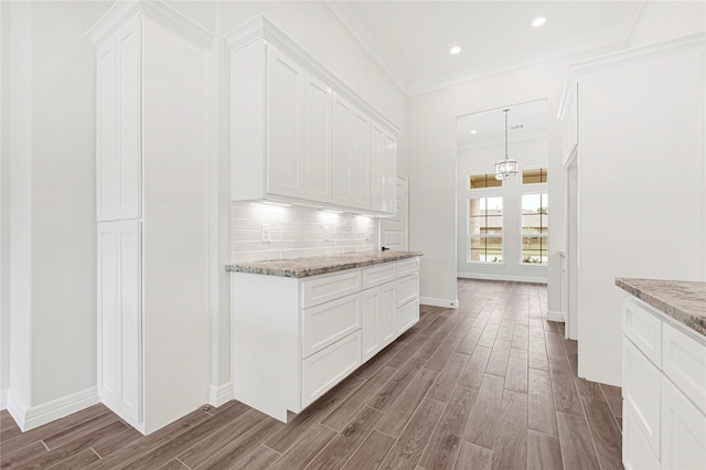 117 Big Spring Dr, Anahuac, TX 77514 - hallway with wood finished floors, baseboards, ornamental molding, and recessed lighting