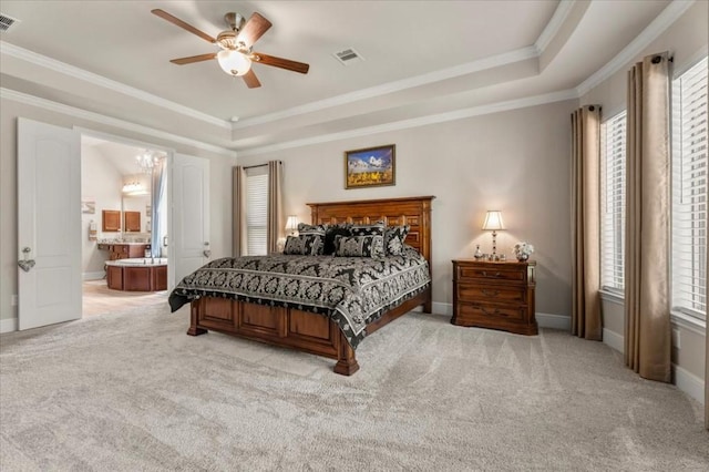 bedroom featuring a raised ceiling, light colored carpet, multiple windows, and ornamental molding