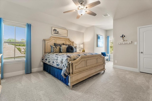 bedroom with light carpet, baseboards, and multiple windows