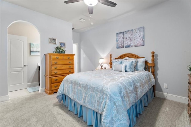 bedroom featuring light carpet, baseboards, and ceiling fan