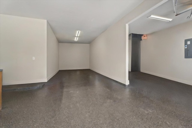 additional living space with baseboards and electric panel