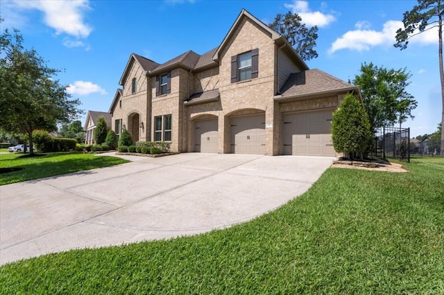 french country home with driveway, brick siding, a shingled roof, a garage, and an attached garage
