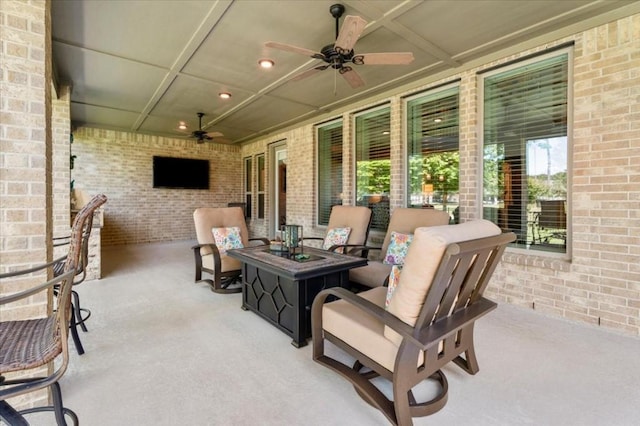 view of patio / terrace with a ceiling fan and a fire pit