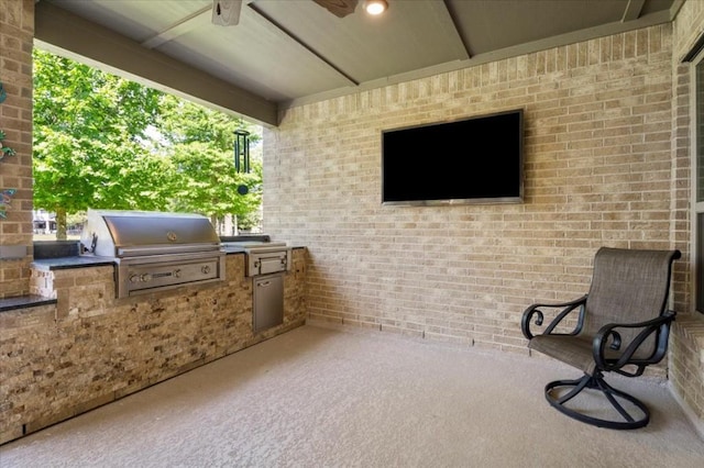 view of patio / terrace with area for grilling, an outdoor kitchen, and a ceiling fan