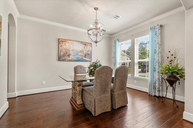 dining area with a chandelier, ornamental molding, dark wood-style floors, baseboards, and arched walkways