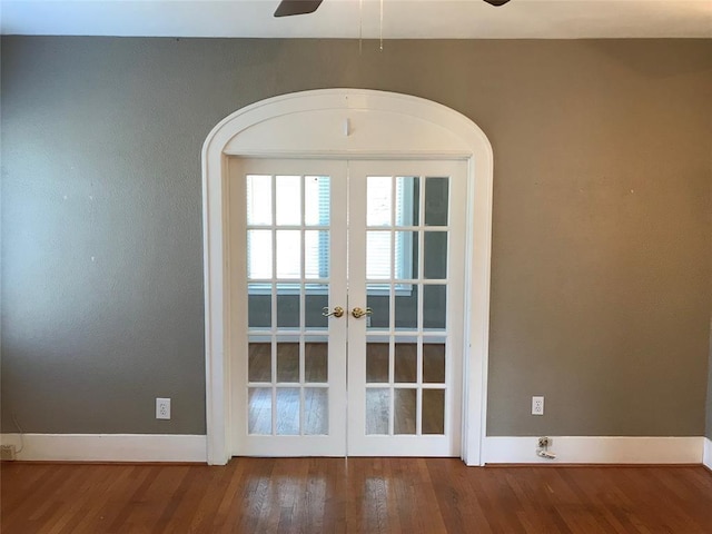 entryway featuring french doors, a ceiling fan, wood finished floors, and baseboards