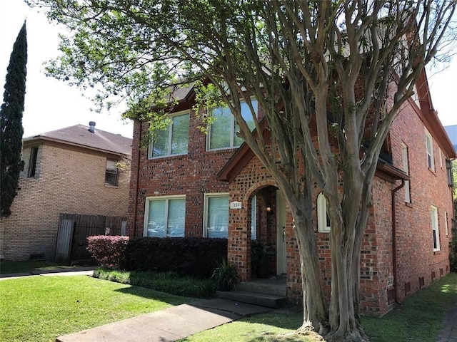 view of front of property featuring brick siding and crawl space