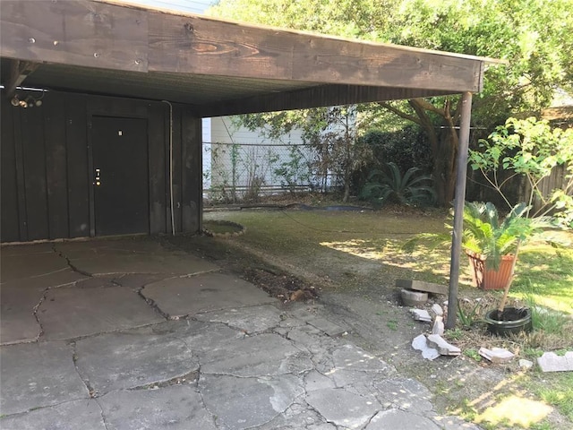 view of yard with fence and a carport