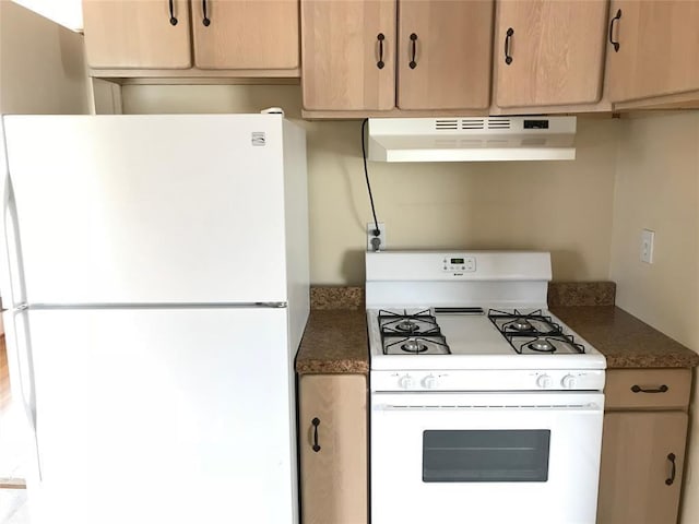 kitchen featuring white appliances, under cabinet range hood, dark countertops, and light brown cabinets