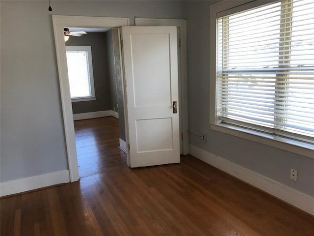 unfurnished room featuring baseboards and wood finished floors