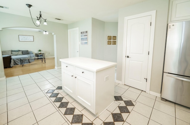 11606 Curry Ridge Ln, Tomball, TX 77377 - kitchen featuring freestanding refrigerator, light tile patterned floors, open floor plan, and white cabinetry