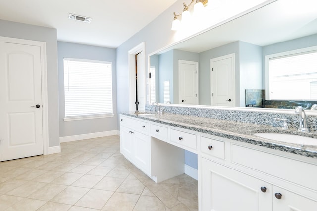 11606 Curry Ridge Ln, Tomball, TX 77377 - bathroom with double vanity, plenty of natural light, tile patterned floors, and baseboards