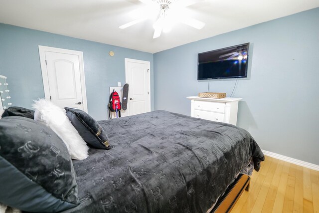 11606 Curry Ridge Ln, Tomball, TX 77377 - bedroom with wood finished floors, baseboards, and ceiling fan